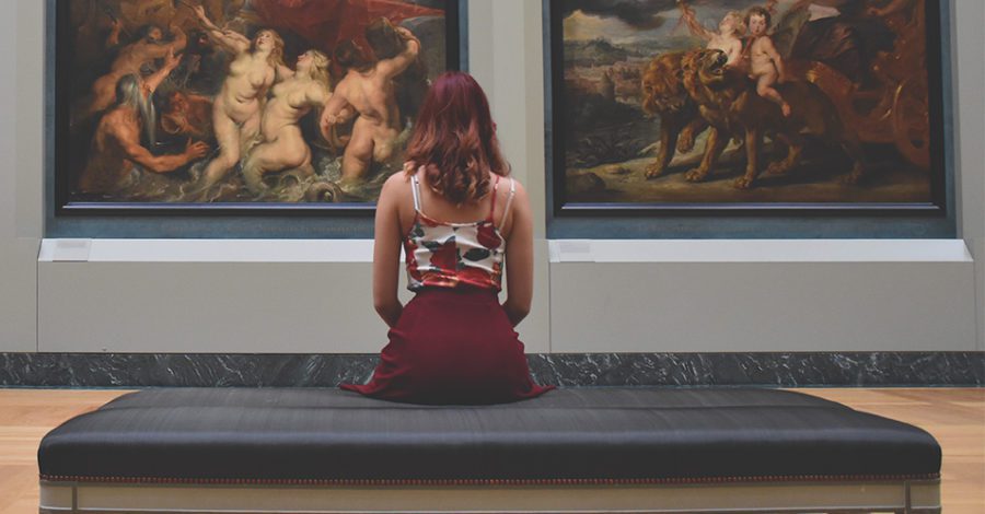 Woman sitting in art gallery