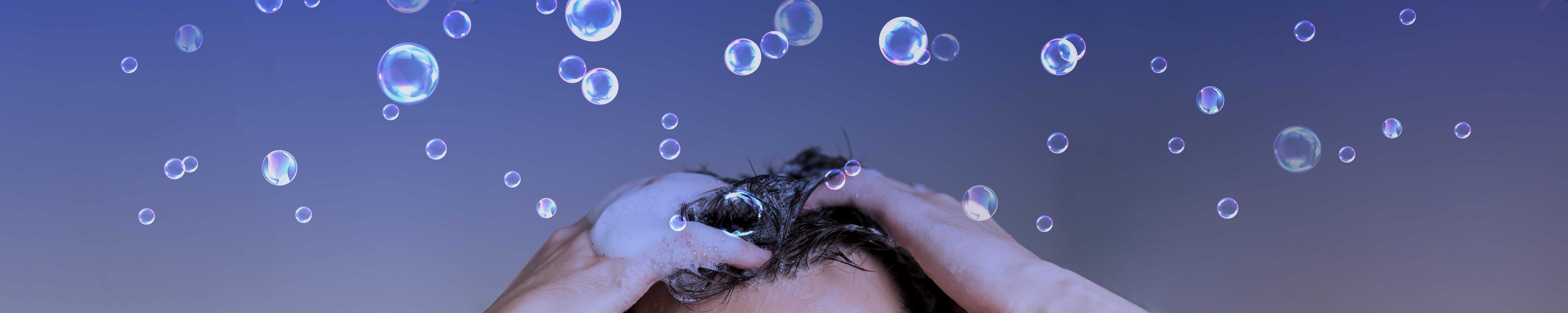Man washing his hair with bubbles banner