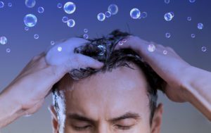 Man washing his hair bubbles